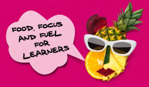 Bright magenta blog graphic featuring the words “Food, Focus and Fuel for Learners” inside a pink speech bubble beside a playful fruit character made from pineapple, orange and beetroot wearing white sunglasses, representing healthy study habits and learner wellbeing.